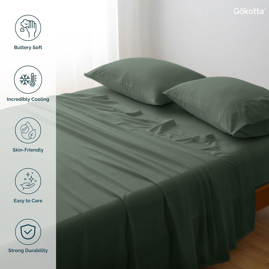 The GOKOTTA sheets laid on a bed, showcasing their combination with other bedding items.