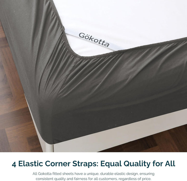 Image showcasing the elastic corner straps on the fitted sheet for a secure fit on the mattress.