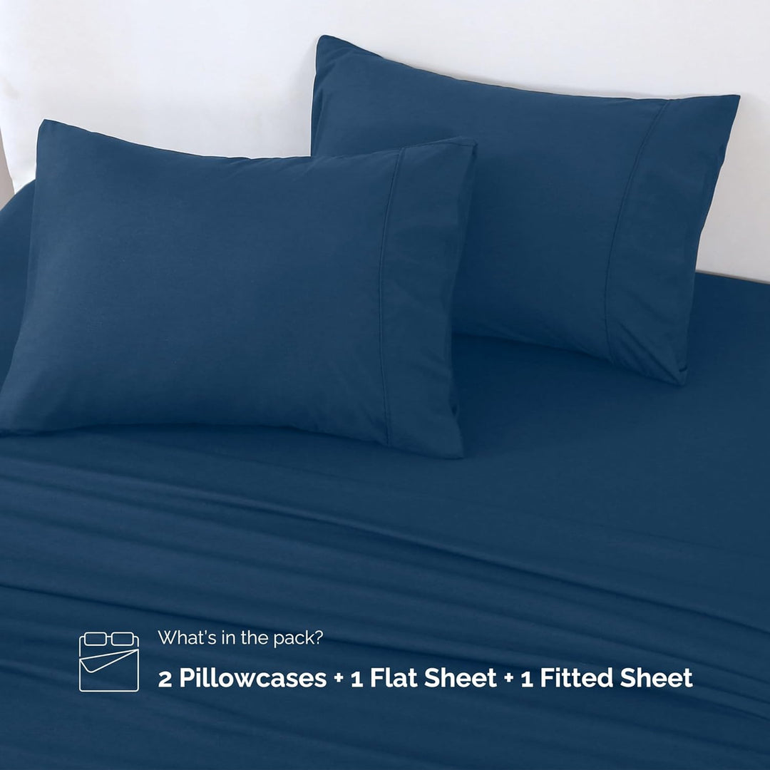 Complete set of GOKOTTA dark blue microfiber sheets, including flat sheet, fitted sheet, and pillowcases.
